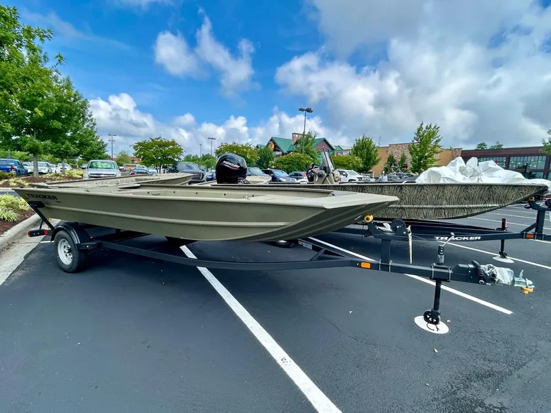 The Image of 2025 Tracker GRIZZLY 1860 Utility boat on trailer in parking lot. - 0