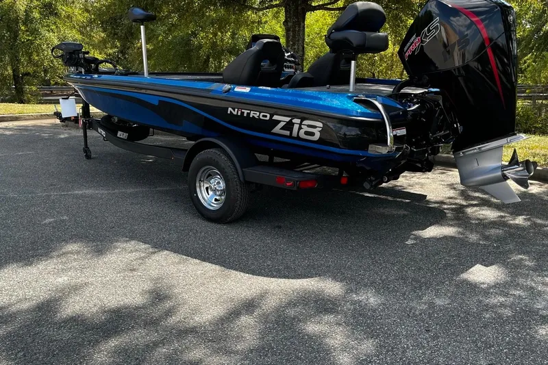 Slide: The Image of 2025 Nitro Z18 boat in blue, parked outdoors, showcasing sleek design and powerful engine. - 3