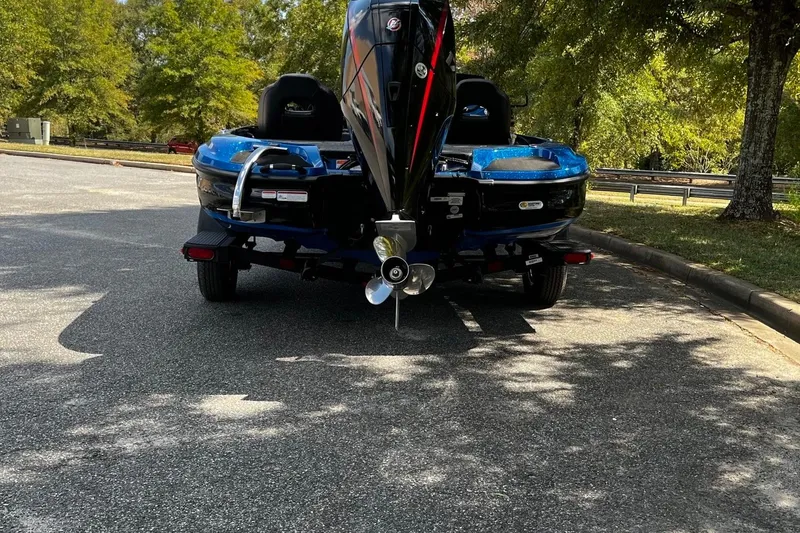 Slide: The Image of 2025 Nitro Z18 boat on trailer, parked under trees in a sunny area. - 4