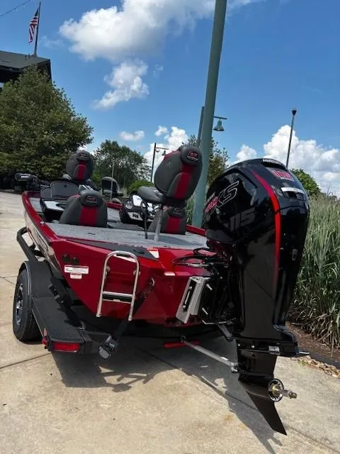 Slide: The Image of 2025 Ranger RT188P boat with powerful outboard motor, parked outdoors under a clear sky. - 3