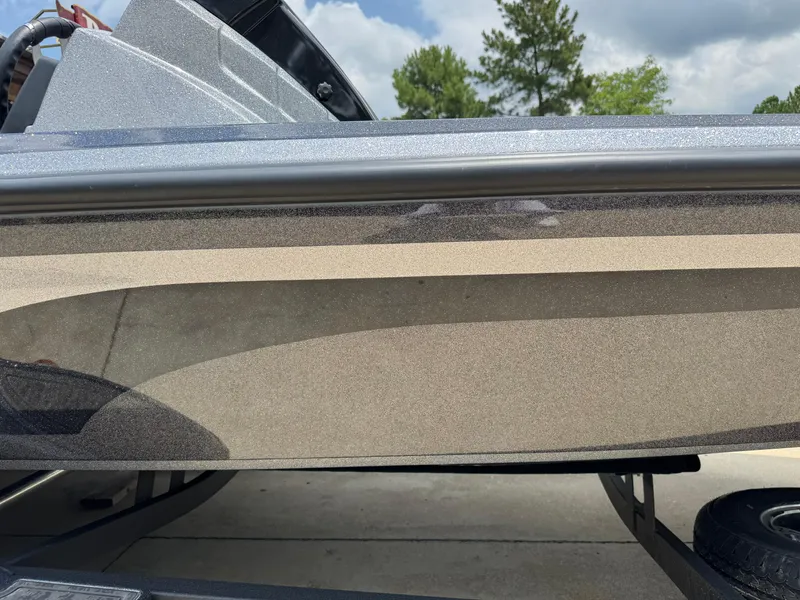 Slide: The Image of 2025 Nitro Z21 XL Pro boat side view with sleek design and metallic finish. - 2