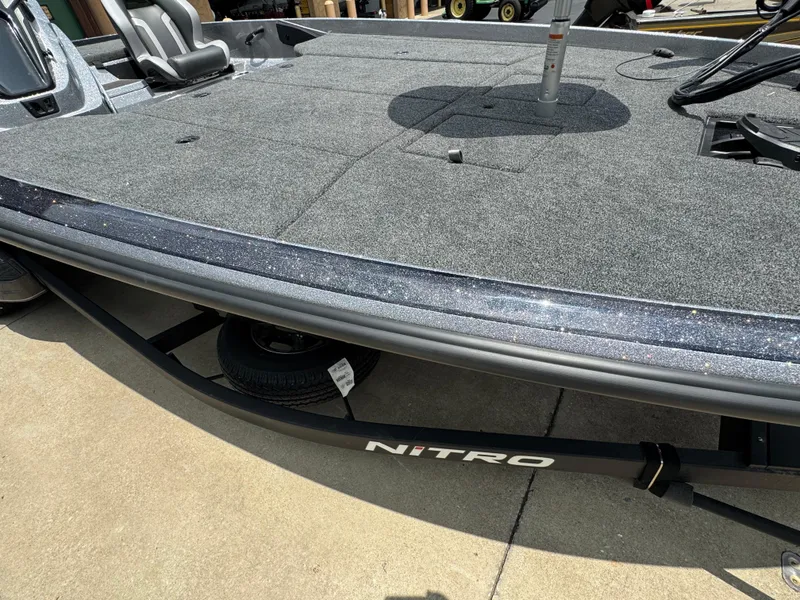 Slide: The Image of 2025 Nitro Z21 XL Pro boat deck with carpeted surface and visible trailer. - 3
