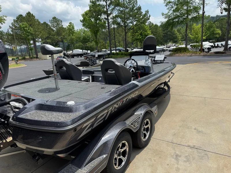 Slide: The Image of 2025 Nitro Z21 XL Pro boat on trailer, parked outdoors with trees in the background. - 5