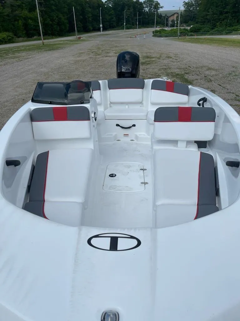 Slide: The Image of 2025 Tahoe T16 boat interior with white and gray seating, steering wheel, and dashboard. - 4