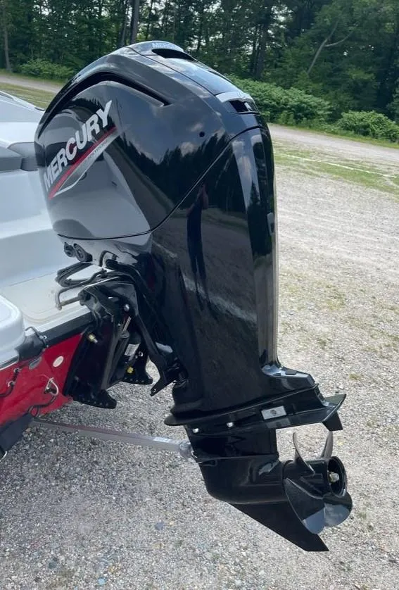 Slide: The Image of 2025 Tahoe T16 boat with Mercury outboard motor in a wooded area. - 7