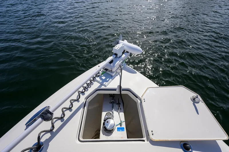 Slide: The Image of 2022 Cobia 350 Center Console boat bow with anchor and calm water. - 12
