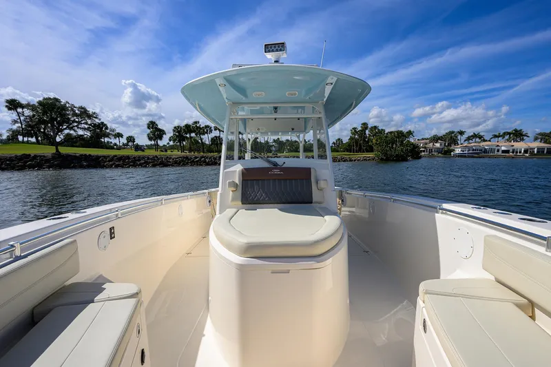 Slide: The Image of 2022 Cobia 350 Center Console boat on water, clear sky, luxurious seating. - 14