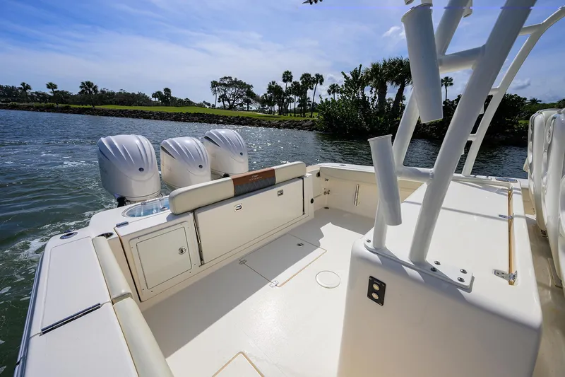 Slide: The Image of 2022 Cobia 350 Center Console boat with triple engines on a sunny day. - 17