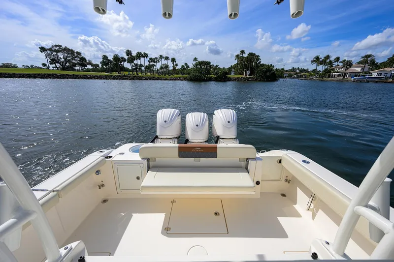 Slide: The Image of 2022 Cobia 350 Center Console boat with triple engines on a scenic waterway. - 19