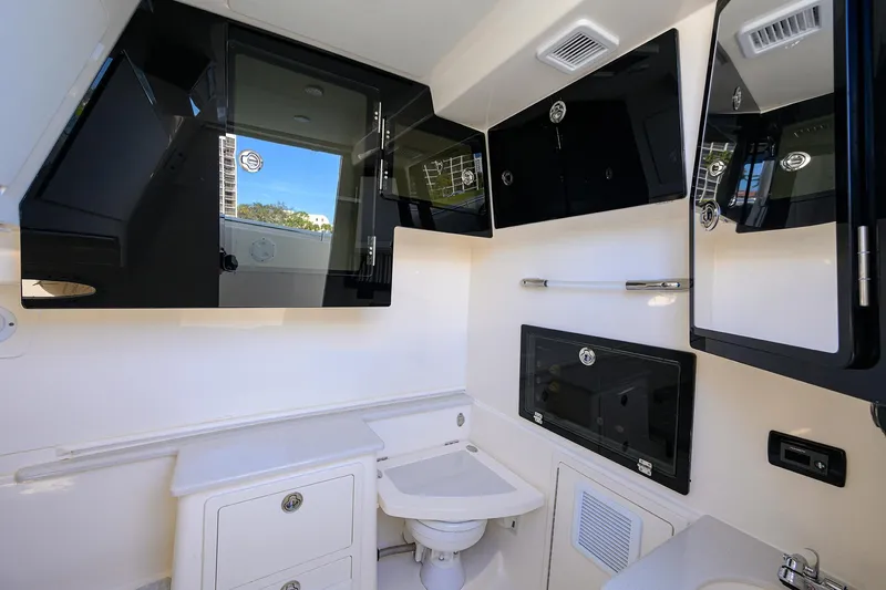 Slide: The Image of 2022 Cobia 350 Center Console boat interior with modern bathroom amenities. - 25