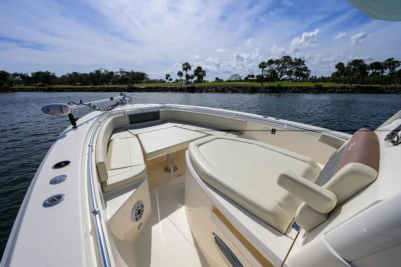 Slide: The Image of 2022 Cobia 350 Center Console boat on calm water, featuring spacious seating and sleek design. - 3