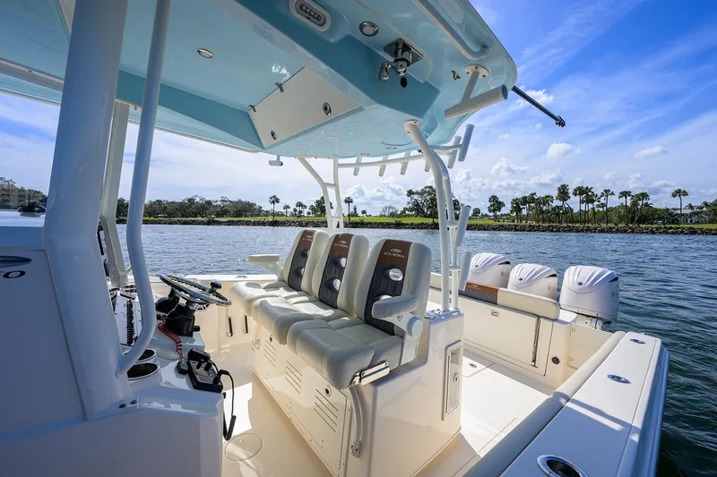 Slide: The Image of 2022 Cobia 350 Center Console boat with seating, on a sunny day by the water. - 34