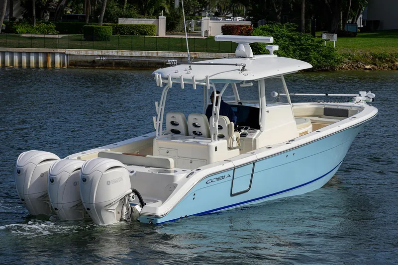 Slide: The Image of 2022 Cobia 350 Center Console boat cruising on a calm waterway. - 35