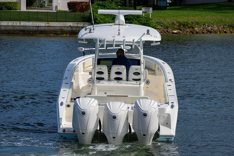 Slide: The Image of 2022 Cobia 350 Center Console boat with triple engines on water. - 5