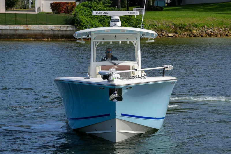 Slide: The Image of 2022 Cobia 350 Center Console boat cruising on a calm waterway. - 6
