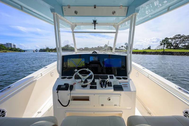 Slide: The Image of 2022 Cobia 350 Center Console boat dashboard with scenic waterway view. - 7