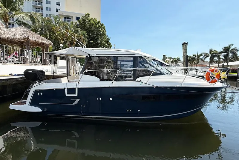 The Image of 2018 Jeanneau NC 895 boat docked in a sunny marina setting. - 0