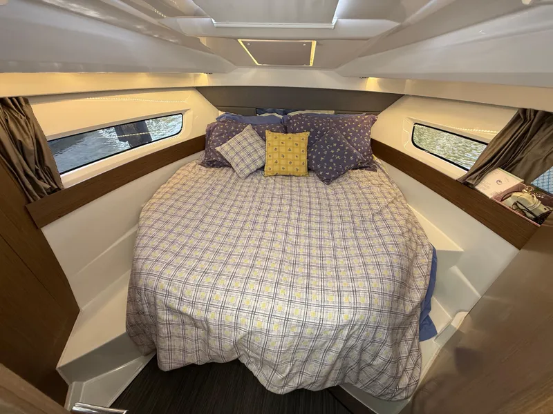 Slide: The Image of Cozy cabin interior of 2018 Jeanneau NC 895 with comfortable bedding and natural light. - 10