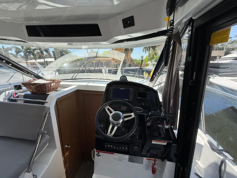 Slide: The Image of 2018 Jeanneau NC 895 boat interior with steering wheel and dashboard. - 17