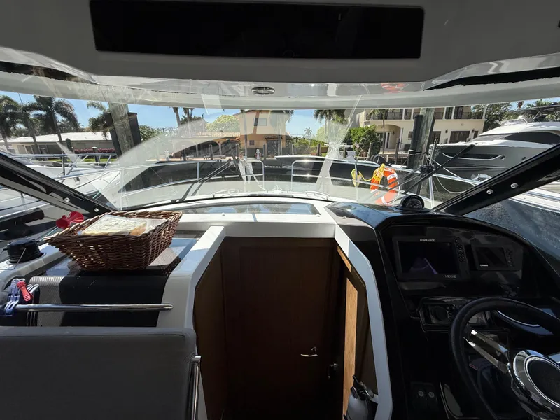 Slide: The Image of Interior view of 2018 Jeanneau NC 895 boat cockpit with steering wheel and dashboard. - 18