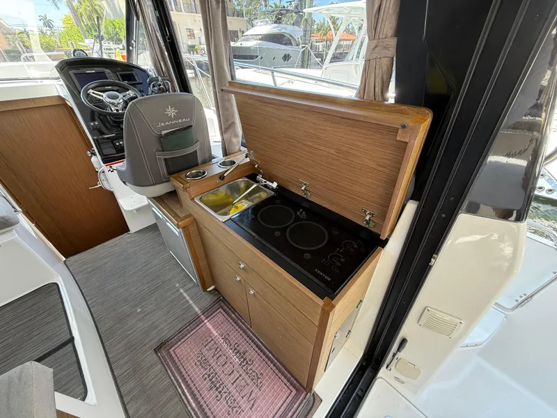 Slide: The Image of Interior of 2018 Jeanneau NC 895 boat with kitchenette and steering area. - 20