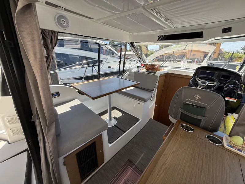 Slide: The Image of Interior of 2018 Jeanneau NC 895 boat with seating, table, and helm station. - 21
