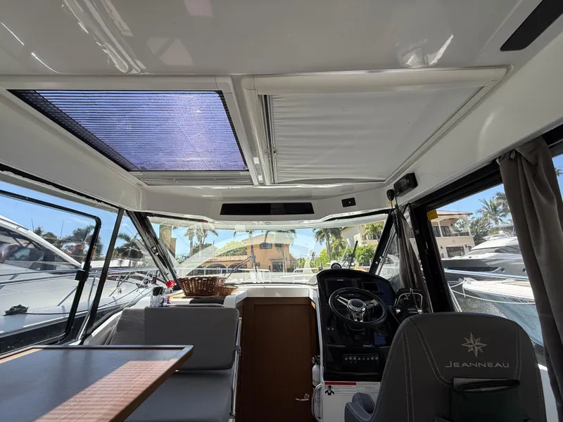 Slide: The Image of Interior of 2018 Jeanneau NC 895 boat with helm, seating, and sunroof. - 22