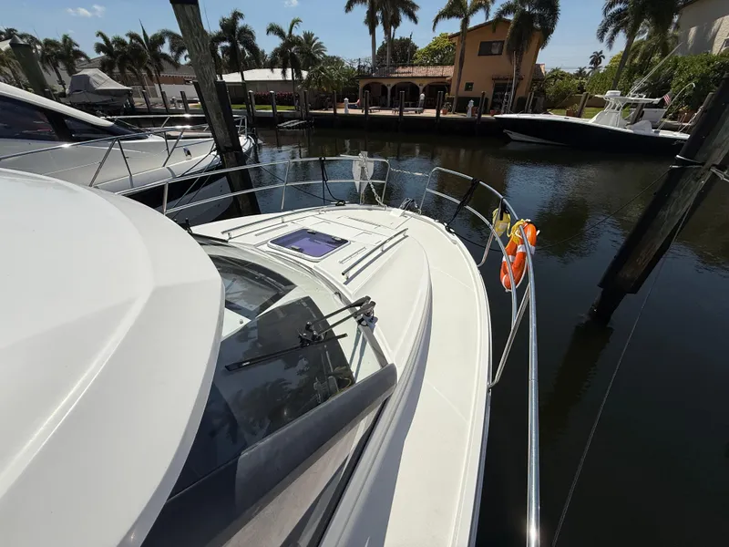 Slide: The Image of 2018 Jeanneau NC 895 boat docked near palm trees and waterfront homes. - 25