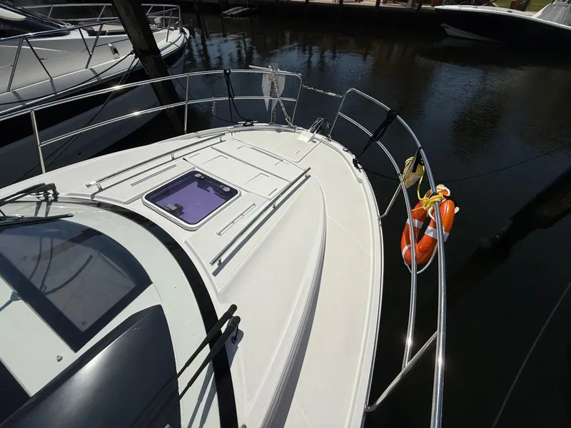 Slide: The Image of 2018 Jeanneau NC 895 boat deck with railing and life rings in marina. - 26