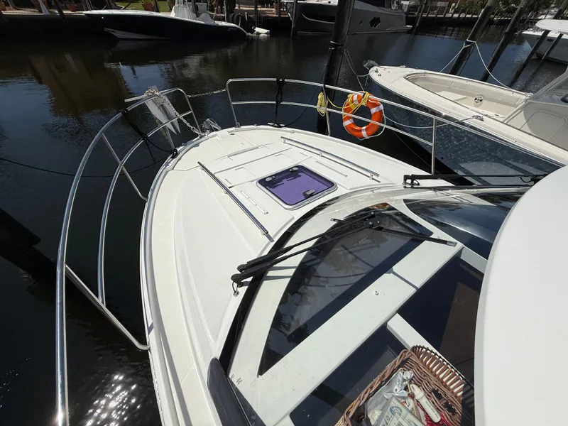 Slide: The Image of 2018 Jeanneau NC 895 boat docked, featuring sleek design and safety railings. - 27