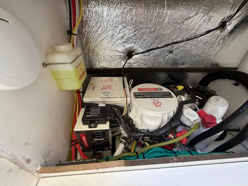 Slide: The Image of Engine compartment of a 2018 Jeanneau NC 895 boat, showcasing mechanical components and wiring. - 36