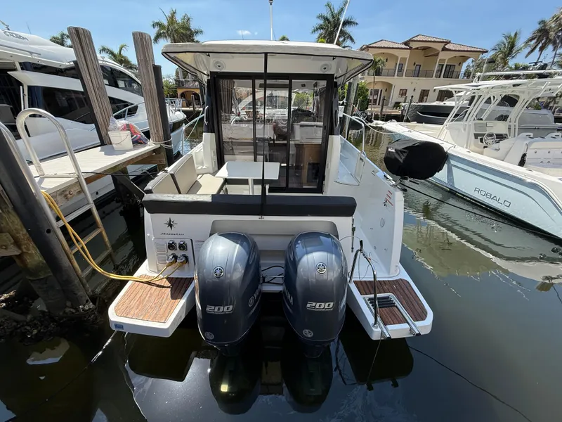 Slide: The Image of 2018 Jeanneau NC 895 boat docked with twin 200 horsepower engines. - 37