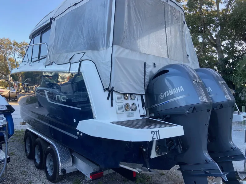 Slide: The Image of 2018 Jeanneau NC 895 boat with twin Yamaha engines on a trailer. - 5