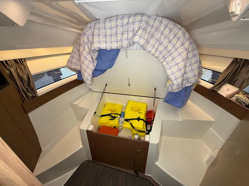 Slide: The Image of 2018 Jeanneau NC 895 cabin interior with life jackets and bedding. - 9