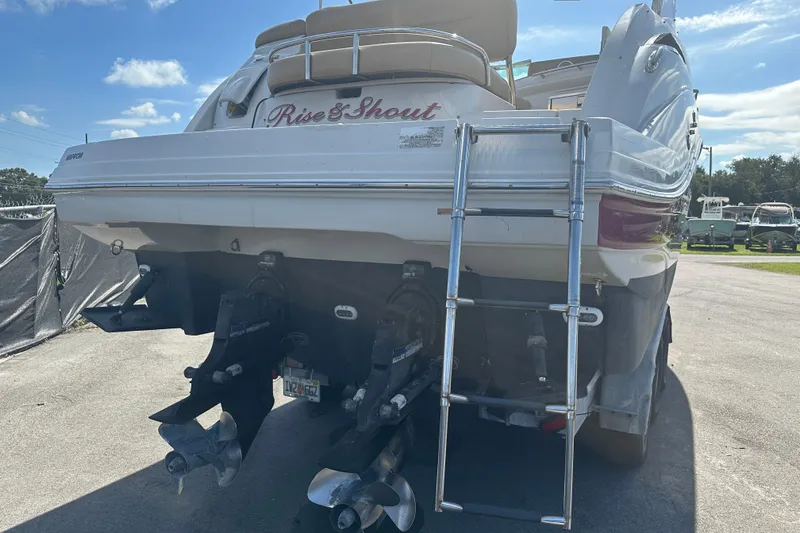 Slide: The Image of 2017 Crownline 294 CR boat with dual propellers and ladder, parked outdoors. - 10