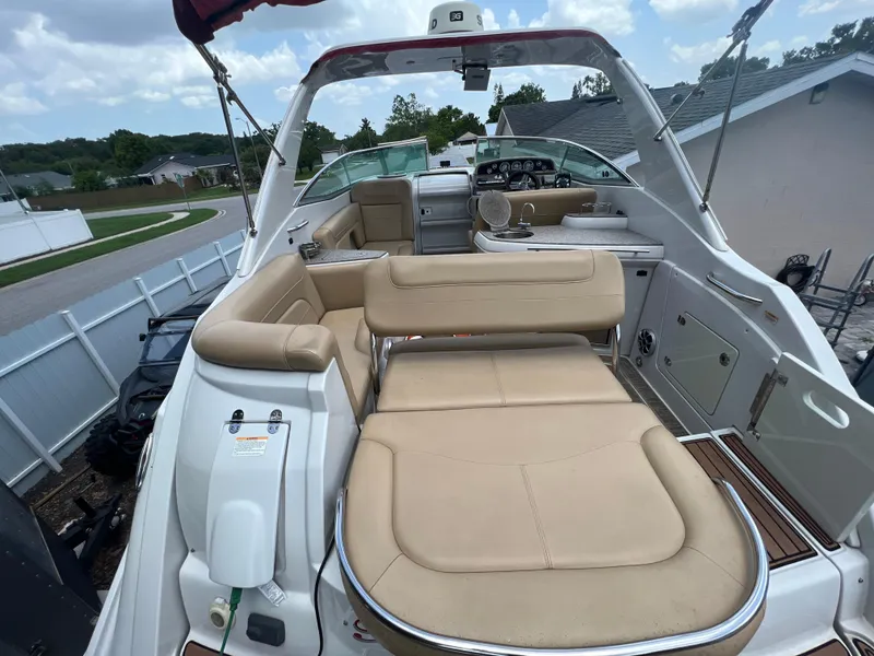 Slide: The Image of 2017 Crownline 294 CR boat with beige seating, spacious deck, and modern controls. - 12