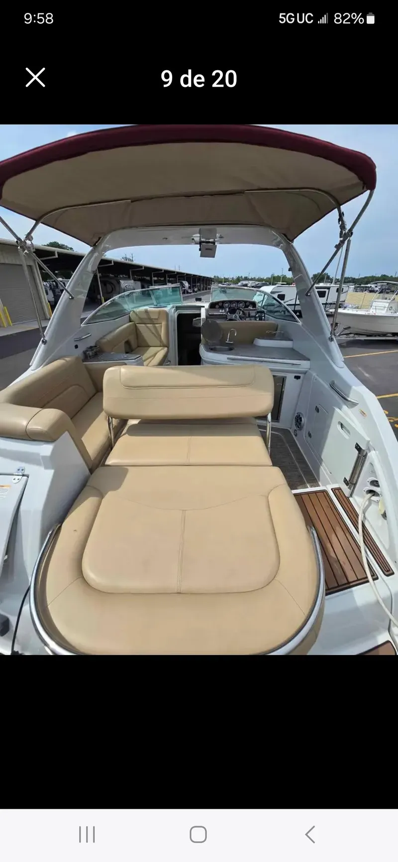 Slide: The Image of 2017 Crownline 294 CR boat with beige seating and canopy, docked at a marina. - 13
