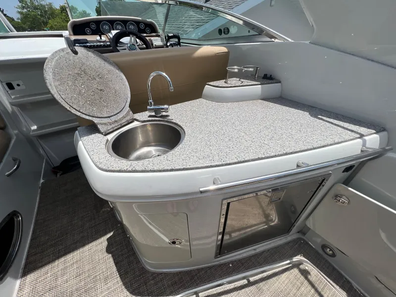 Slide: The Image of 2017 Crownline 294 CR boat interior with kitchenette, sink, and countertop. - 18