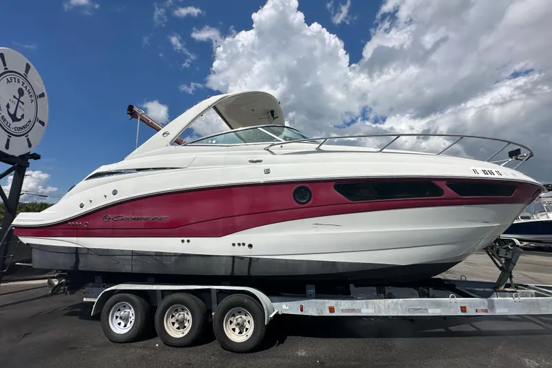 Slide: The Image of 2017 Crownline 294 CR boat on trailer under cloudy sky. - 2