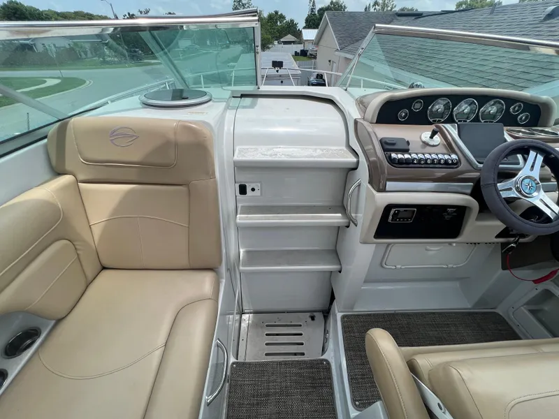 Slide: The Image of 2017 Crownline 294 CR boat cockpit with beige seating and modern dashboard. - 28