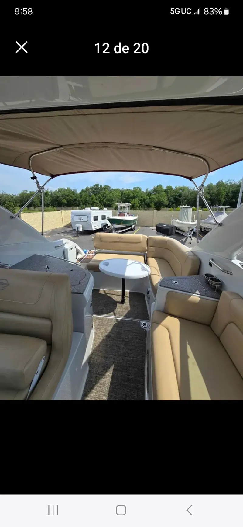 Slide: The Image of 2017 Crownline 294 CR boat interior with beige seating and canopy. - 29