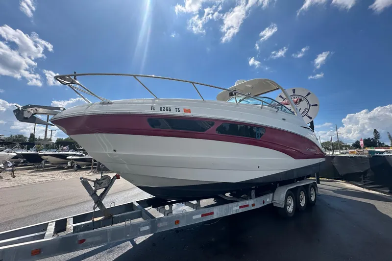 Slide: The Image of 2017 Crownline 294 CR boat on trailer under a sunny sky. - 3