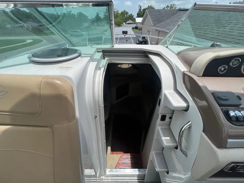 Slide: The Image of 2017 Crownline 294 CR boat interior entrance with dashboard and seating area. - 30