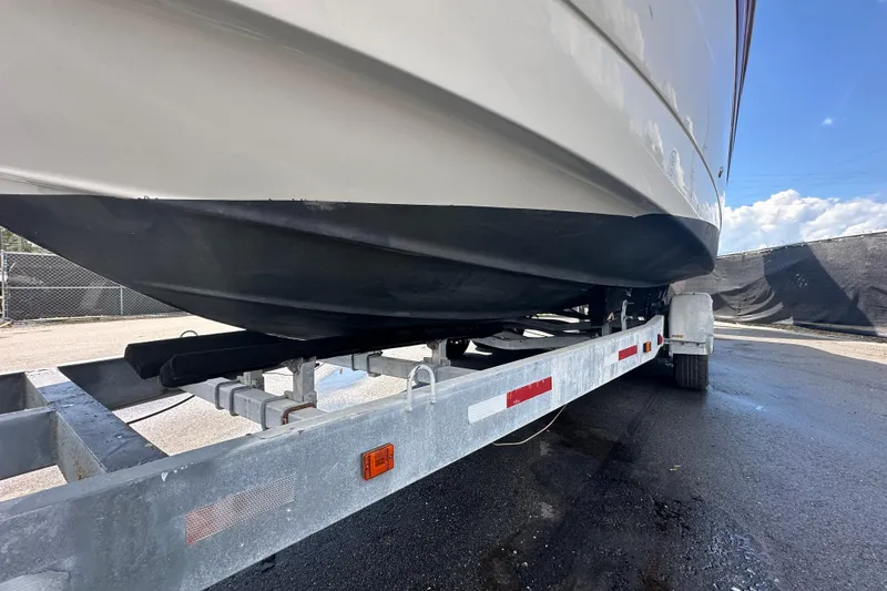 Slide: The Image of 2017 Crownline 294 CR boat on trailer, viewed from below, sunny day. - 4