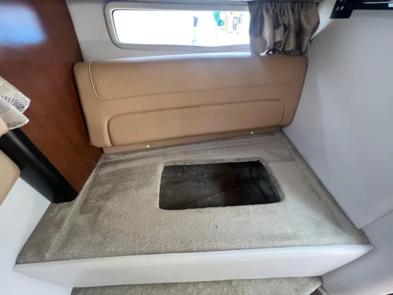 Slide: The Image of Interior cabin of 2017 Crownline 294 CR boat with beige seating and window. - 41