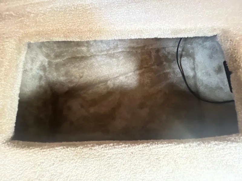 Slide: The Image of Storage compartment in 2017 Crownline 294 CR boat, featuring carpeted interior and wiring. - 42