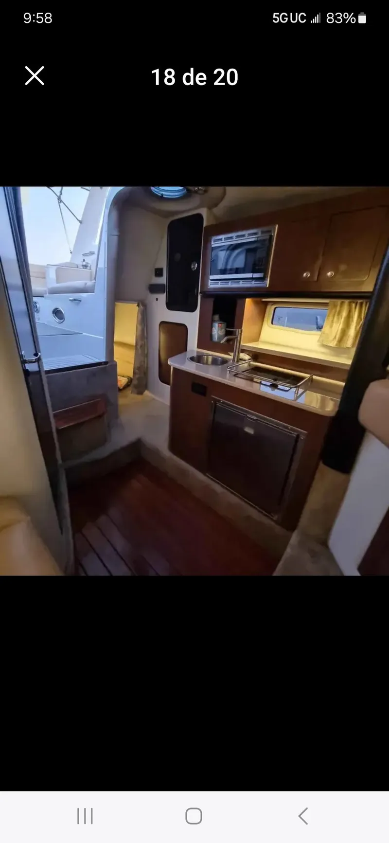 Slide: The Image of 2017 Crownline 294 CR cabin interior with kitchenette and wood flooring. - 43