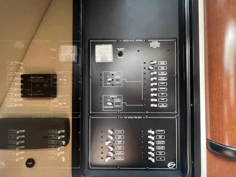 Slide: The Image of Electrical control panel on a 2017 Crownline 294 CR boat, featuring switches and circuit breakers. - 45