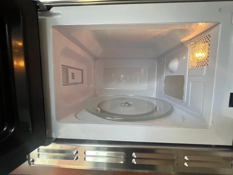 Slide: The Image of Open microwave oven inside a 2017 Crownline 294 CR boat kitchen. - 47