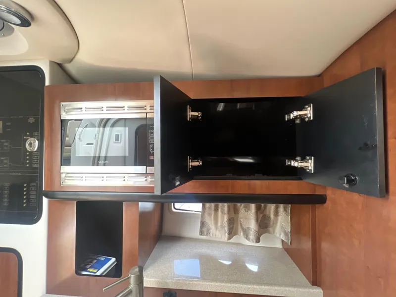 Slide: The Image of 2017 Crownline 294 CR interior with open cabinet and modern design. - 48